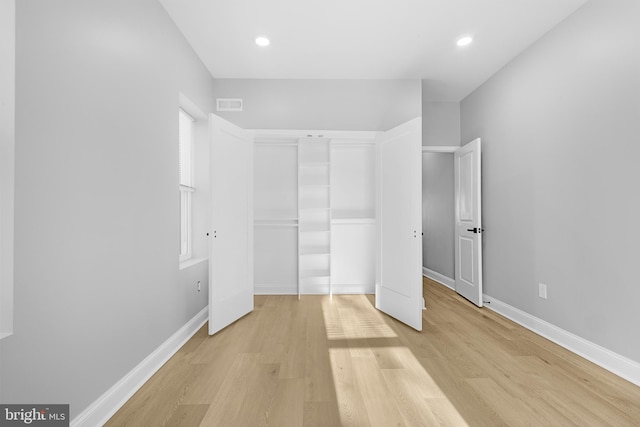 unfurnished bedroom featuring a closet and light hardwood / wood-style floors