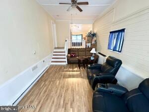 living room featuring ceiling fan and wood-type flooring