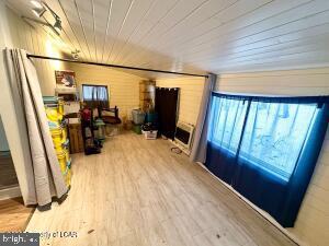 interior space featuring hardwood / wood-style floors and wood ceiling