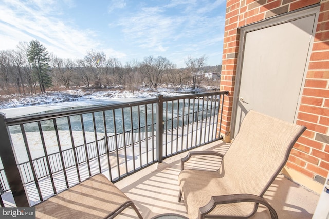 view of snow covered back of property