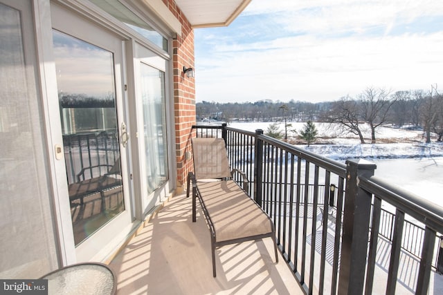 view of snow covered back of property