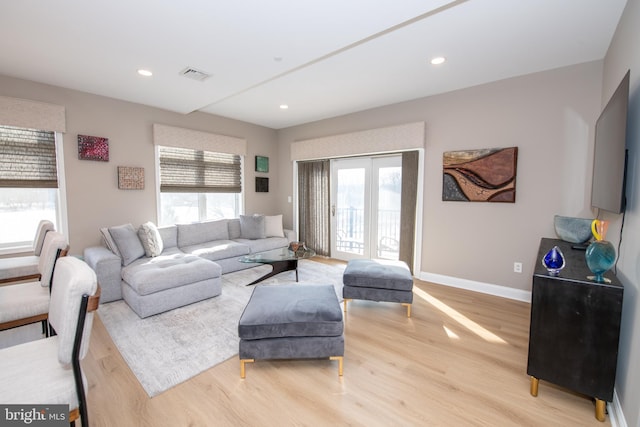 living room featuring plenty of natural light and light wood-type flooring