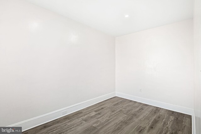 spare room with dark hardwood / wood-style flooring