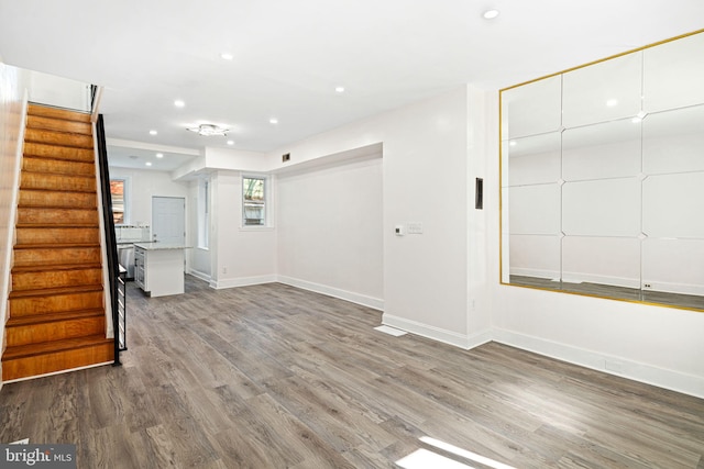 unfurnished living room featuring wood-type flooring