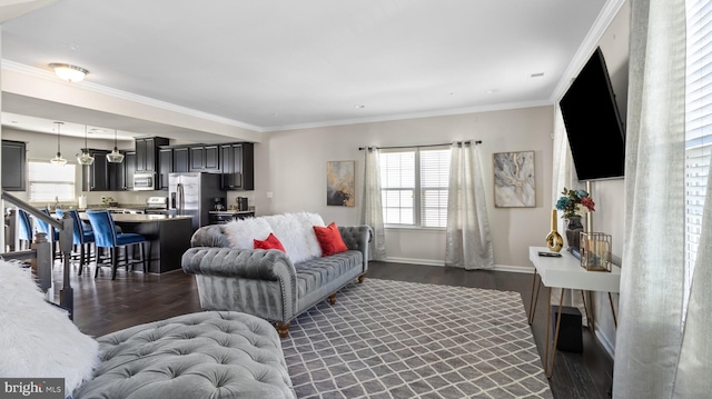 living room with dark wood-type flooring and ornamental molding