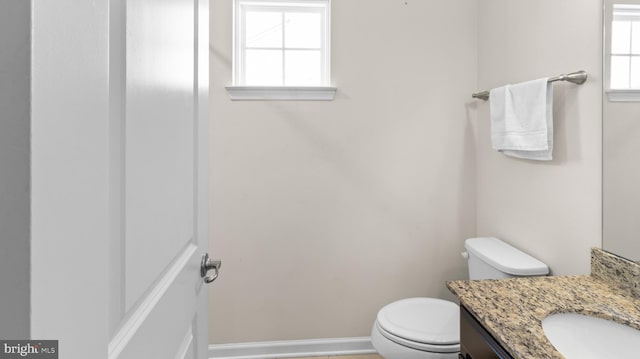 bathroom featuring toilet and vanity