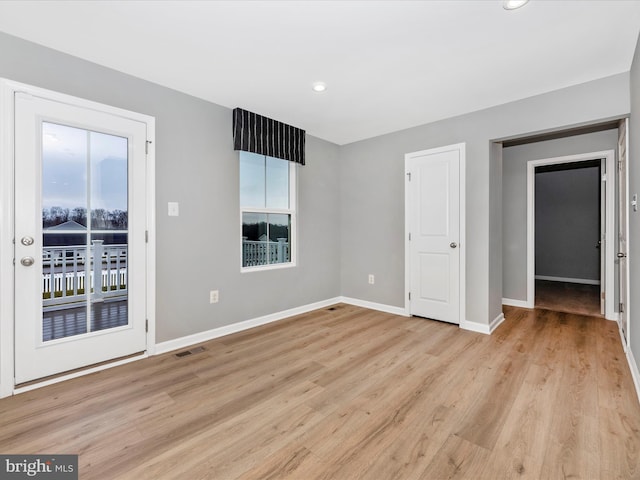 spare room with light hardwood / wood-style floors