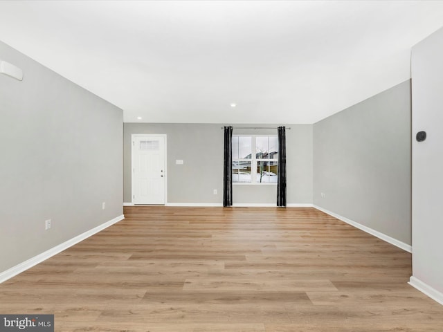 spare room featuring light wood-type flooring