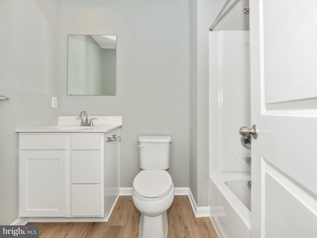 full bathroom with toilet,  shower combination, wood-type flooring, and vanity