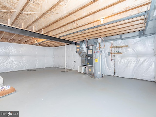 basement featuring heating unit and electric water heater