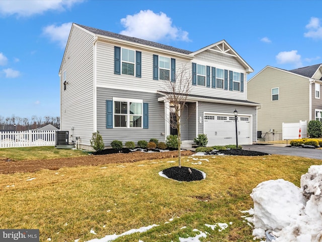 view of front of house with a garage, cooling unit, and a front lawn