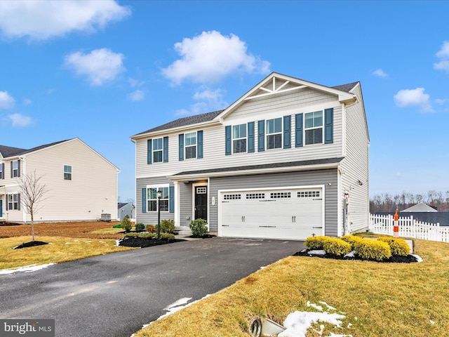 view of front of home featuring a garage and a front lawn