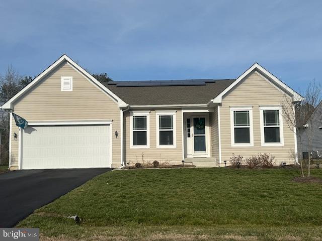 single story home with a front yard and a garage