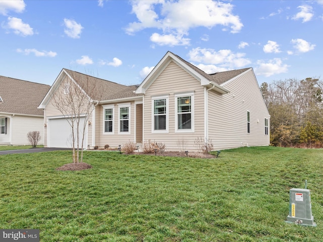 view of front of home featuring a garage and a front lawn