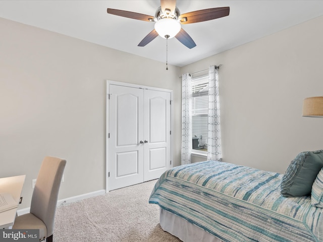 bedroom featuring light carpet, a closet, and ceiling fan