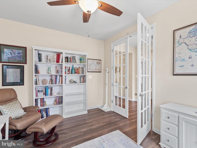 sitting room featuring french doors, ceiling fan, and dark wood-type flooring