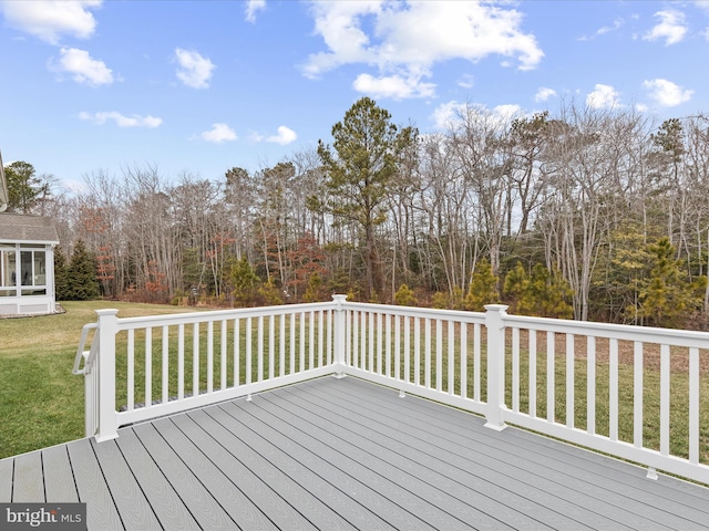 deck featuring a lawn and a sunroom