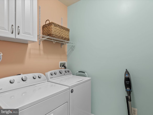 laundry area featuring independent washer and dryer and cabinets