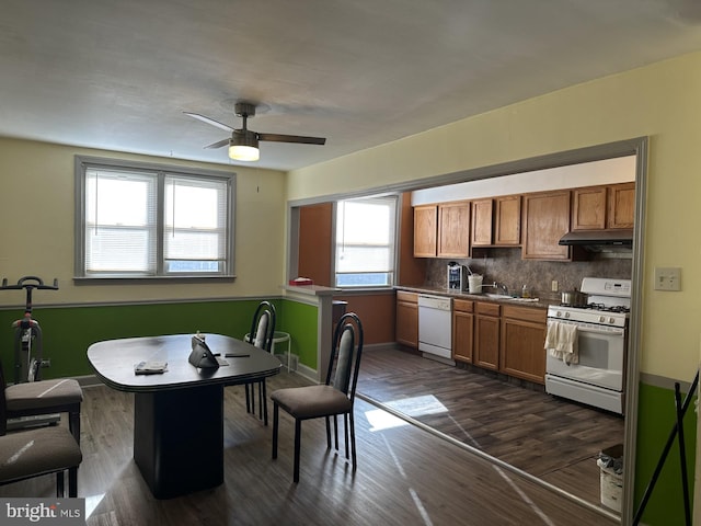 dining space featuring ceiling fan and dark wood-type flooring