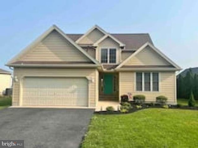 view of front of house with a front yard and a garage