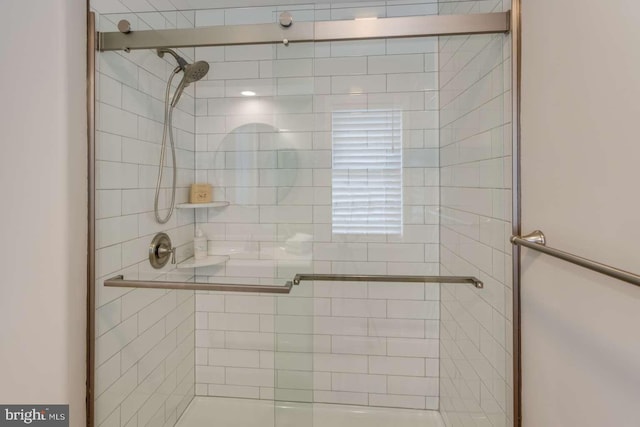 bathroom with a shower with shower door