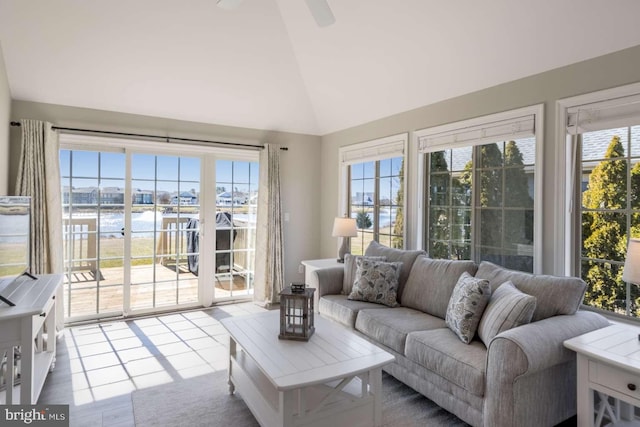 sunroom / solarium featuring a water view, ceiling fan, and lofted ceiling