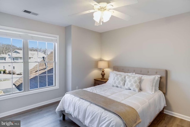 bedroom with ceiling fan and dark wood-type flooring