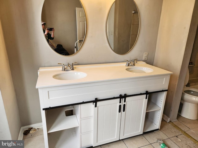 bathroom with toilet, tile patterned floors, and vanity