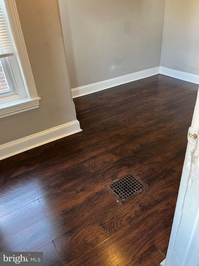 spare room with dark hardwood / wood-style flooring