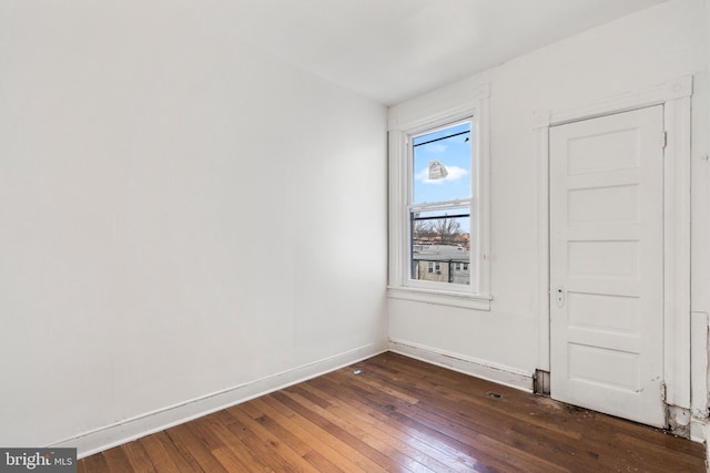 spare room featuring dark wood-type flooring