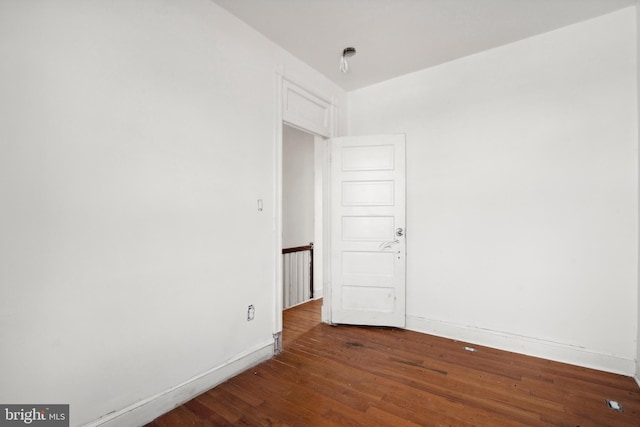 empty room with dark wood-type flooring