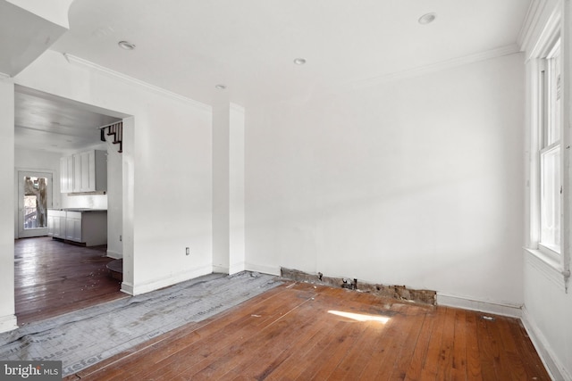 spare room with dark wood-type flooring and ornamental molding