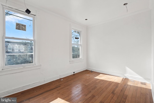 empty room featuring crown molding and hardwood / wood-style floors