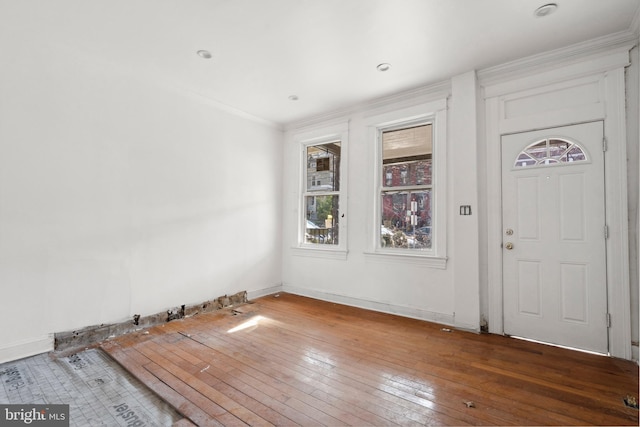 entryway with crown molding and dark wood-type flooring