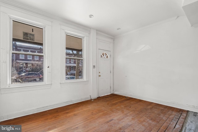 unfurnished room featuring crown molding and hardwood / wood-style flooring