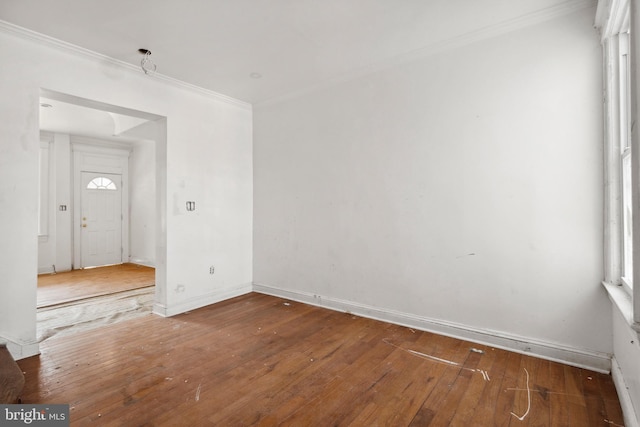 unfurnished room with ornamental molding and hardwood / wood-style floors