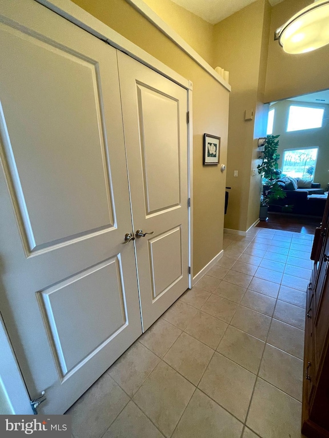 hall with light tile patterned floors