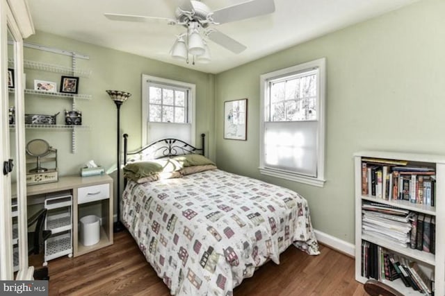 bedroom with dark wood finished floors, baseboards, and ceiling fan