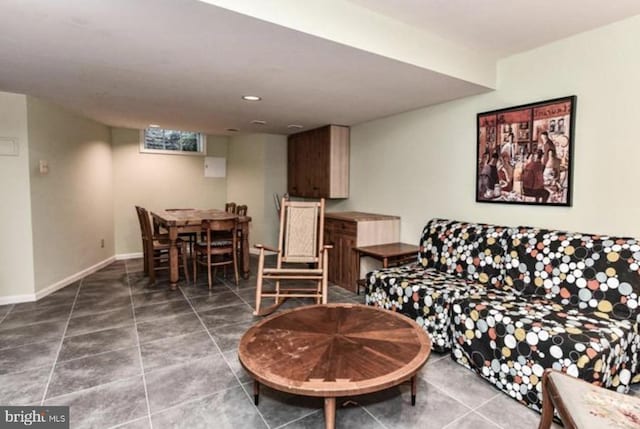 living area featuring tile patterned flooring and baseboards