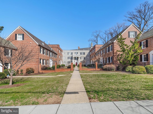 surrounding community featuring a fenced front yard, a residential view, and a lawn