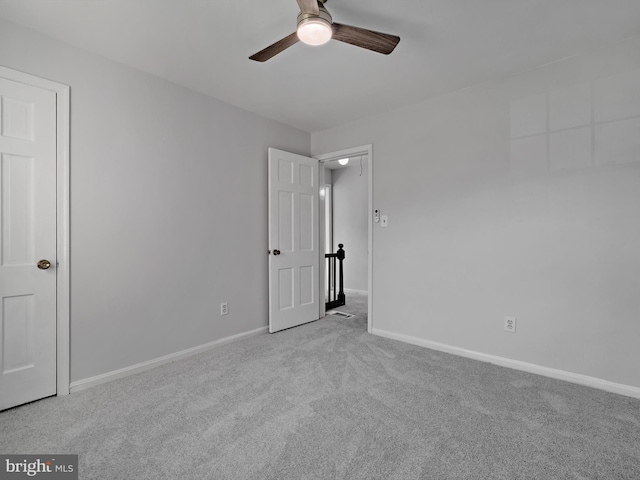 unfurnished bedroom featuring carpet floors, ceiling fan, and baseboards