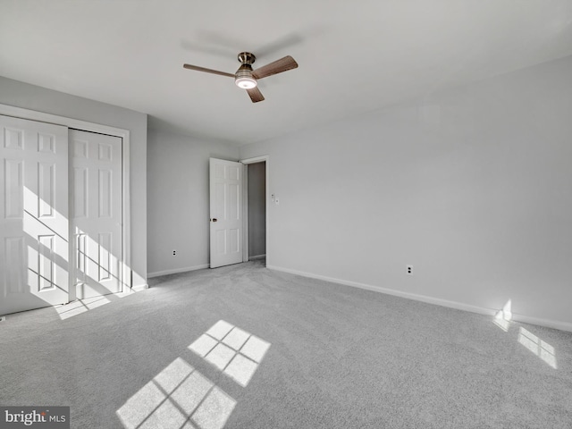 unfurnished bedroom featuring a closet, carpet flooring, ceiling fan, and baseboards