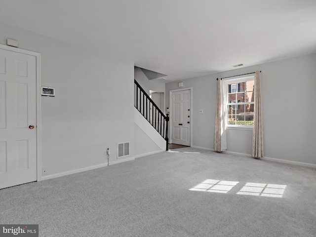 interior space with stairs, carpet, visible vents, and baseboards