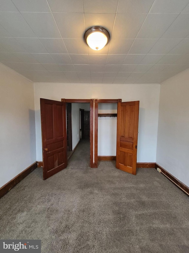 unfurnished bedroom featuring dark colored carpet