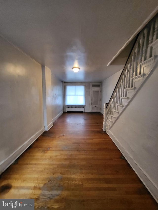 interior space with dark wood-type flooring and radiator