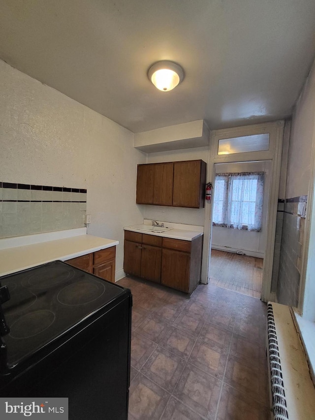 kitchen with sink and black / electric stove