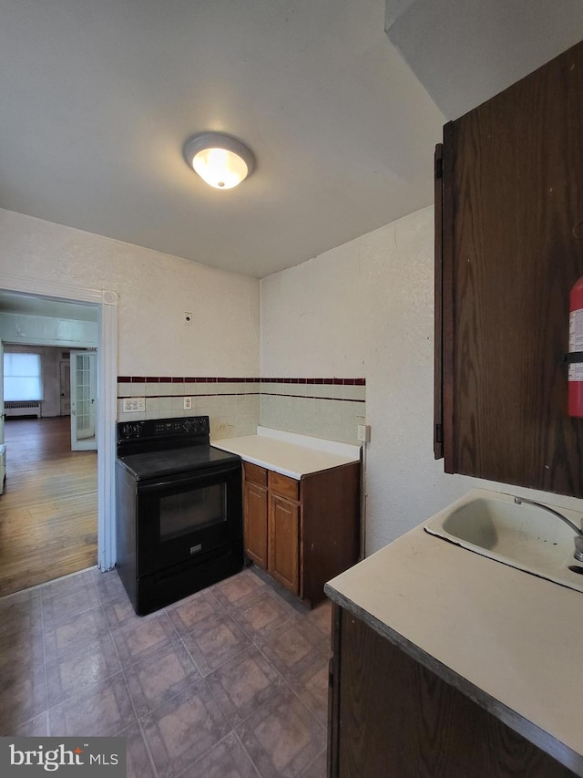 kitchen with sink and black electric range oven