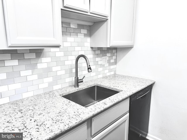 kitchen with dishwasher, white cabinets, backsplash, and sink