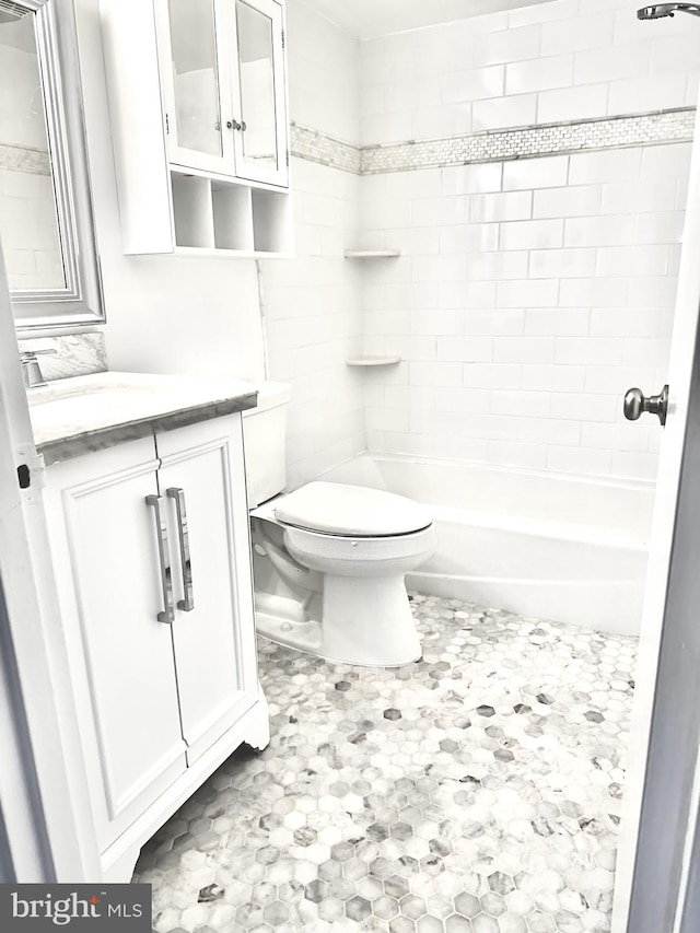 full bathroom with toilet, tiled shower / bath, and vanity