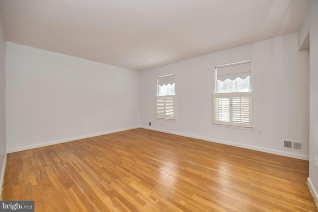 unfurnished room with light hardwood / wood-style floors